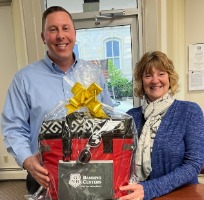 Prize winner holding gift basket.